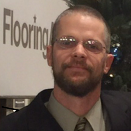 Man in front of flooring van