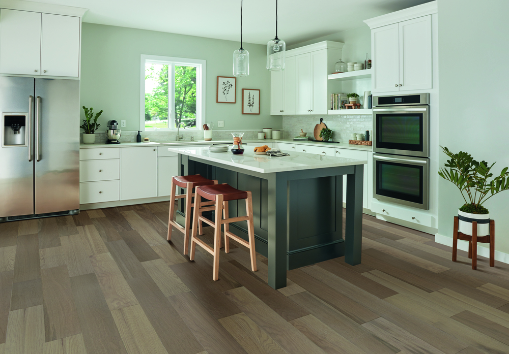 wood flooring installation in kitchen with custom cabinets and countertops