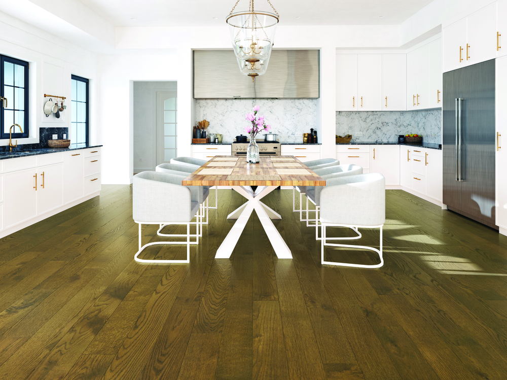 wood flooring installation in kitchen with white cabinets and black stone countertops