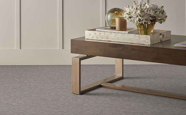 grey carpet with brown coffee table