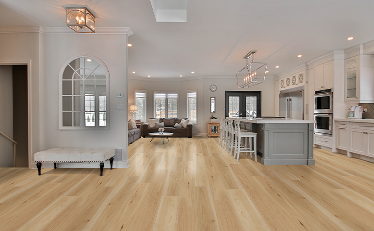 luxury vinyl kitchen with tan flooring and grey island