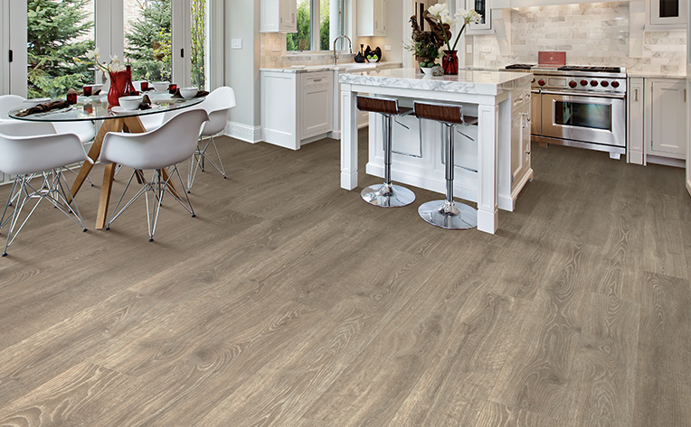laminate floors in kitchen with glass table and white chairs